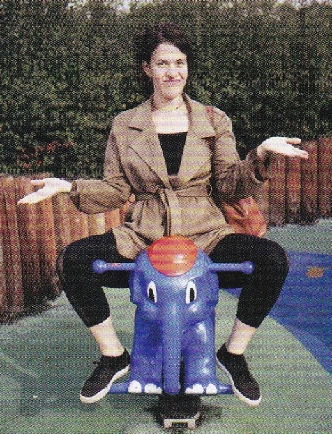 A person sitting on a toy elephant
AI-generated content may be incorrect.
